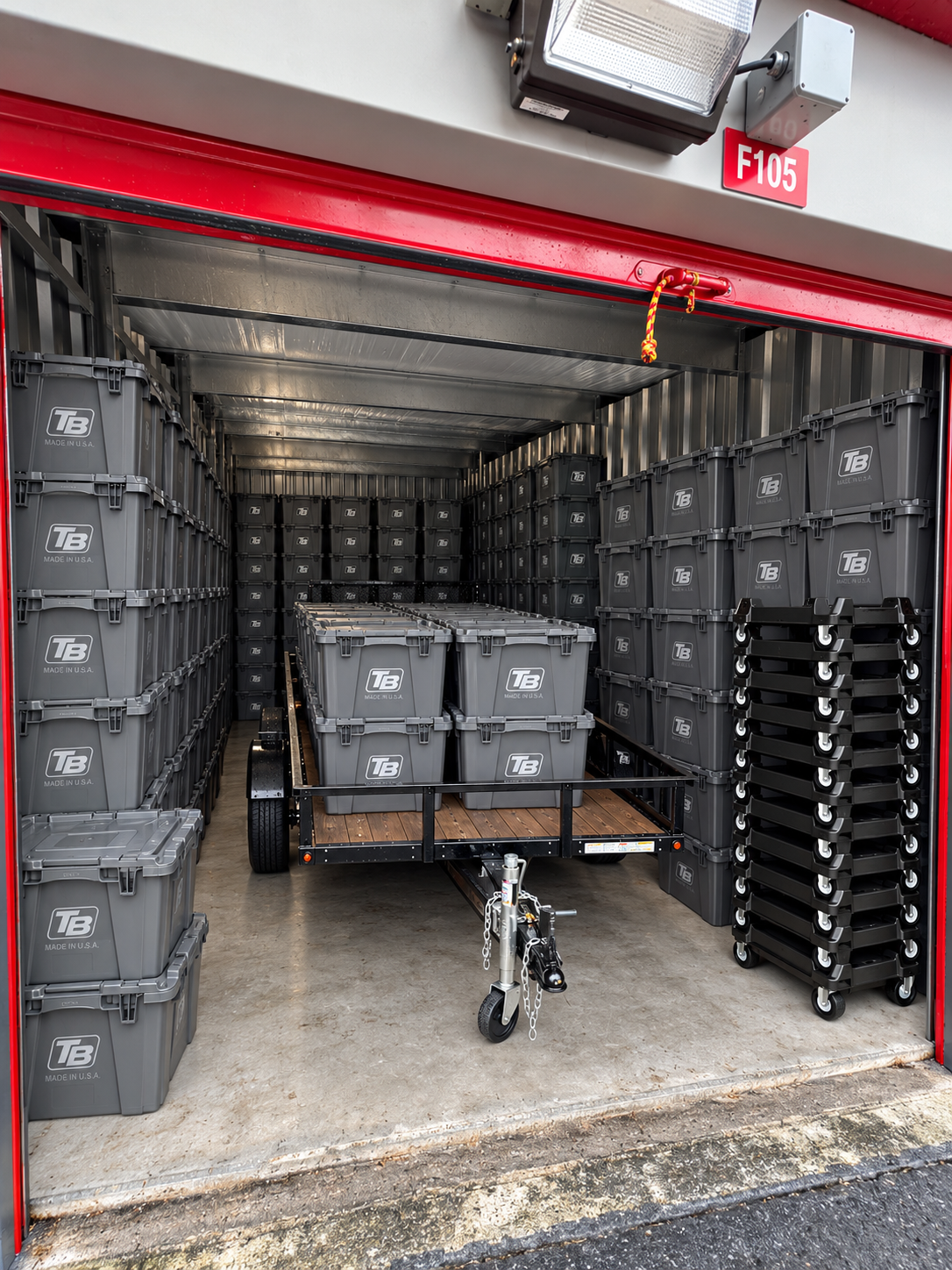 Tampa Bin Co storage unit packed with TB branded bins and trailer